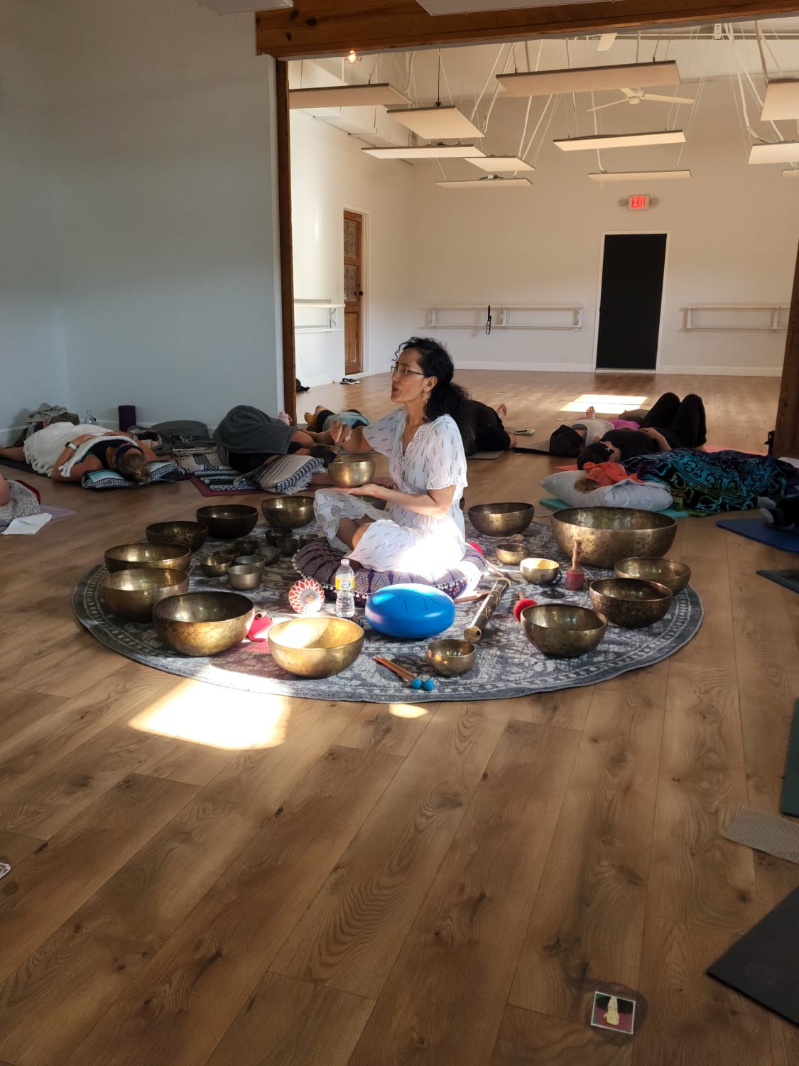 Adwiti playing a Himalayan singing bowl while the group rests.